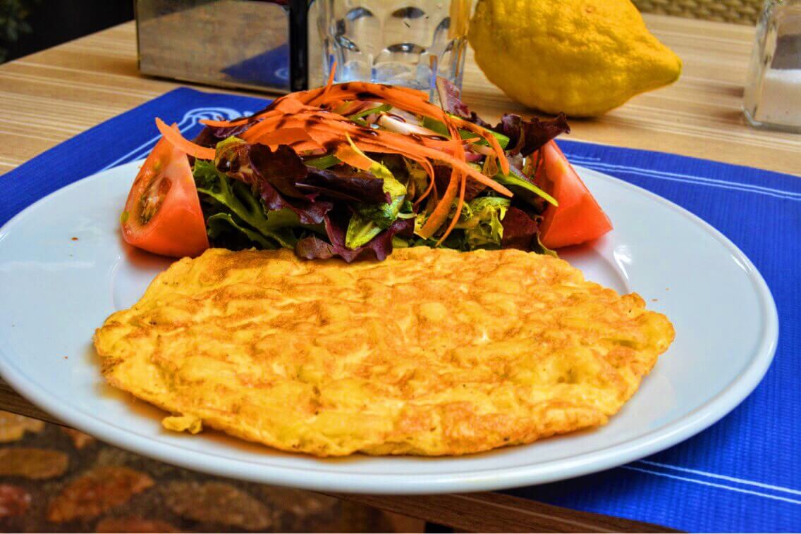A spanish omelete with lots of vegetable