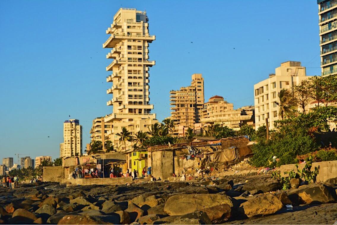 This is the view of the rocks and slums alongside the big residential buildings near Bandra in Mumbai