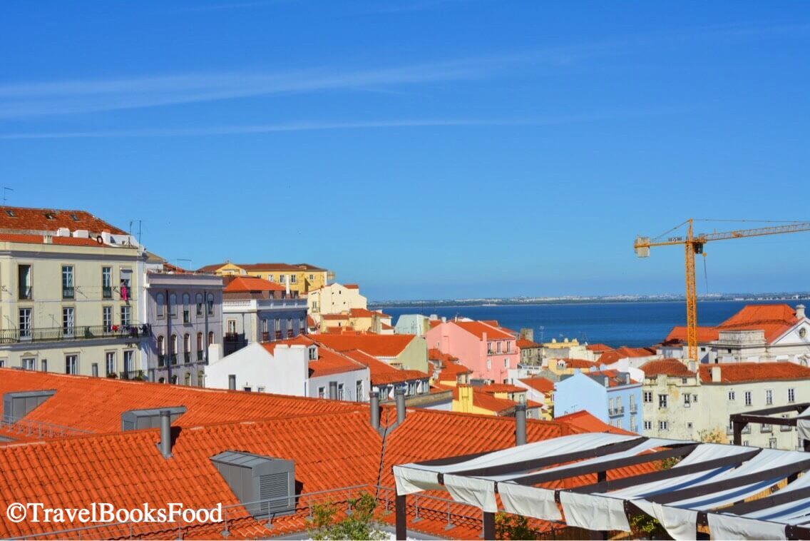 This is one of the many viewpoints in Lisbon. Here you can see the view of many houses with a water body in the background