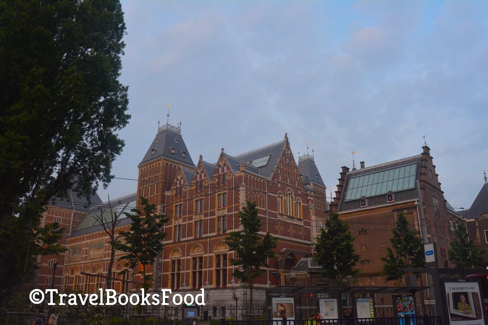 This is a photo of Rijksmuseum in Amsterdam. This is a big looking orangish brown building