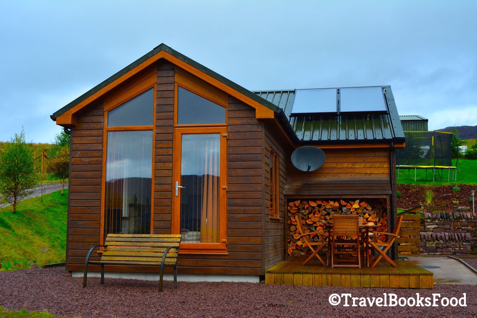 Our gorgeous wooden chalet/ cottage in Kyle of Lochalsh in Isle of Skye, Scotland. There are three chairs and a bench to enjoy the view of the first image.