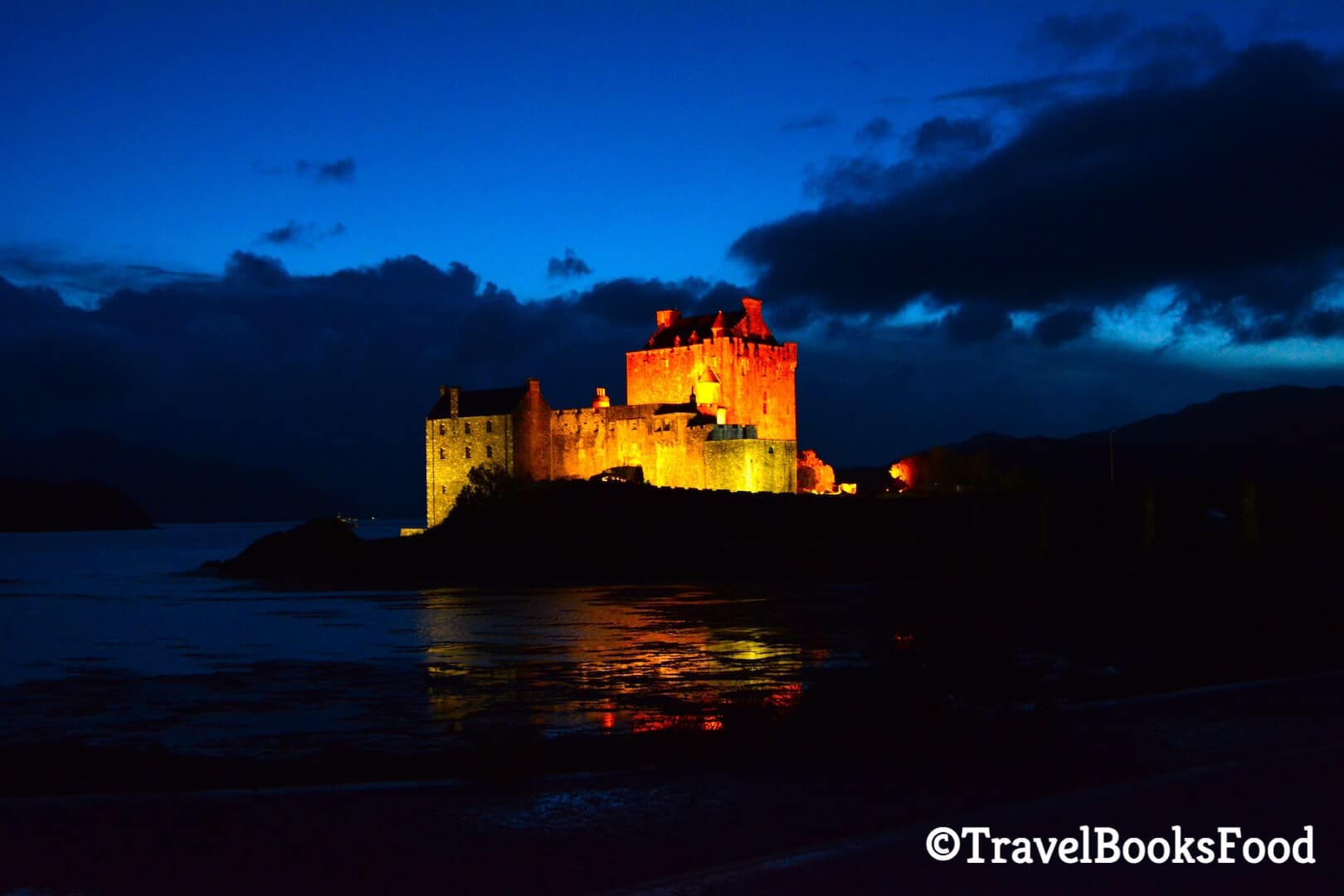 A nighttime photo of the Eilean Donan Castle in Isle of Skye.