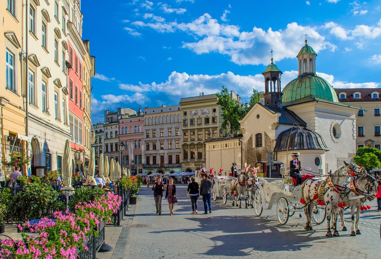 Old town in Poland with colorful buildings and few horse carriages
