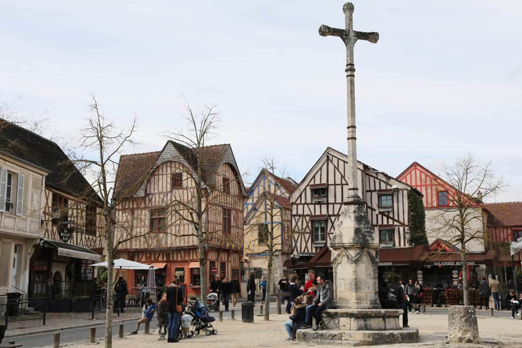 In this photo, you see a sqaure surrounded by timbered buildings