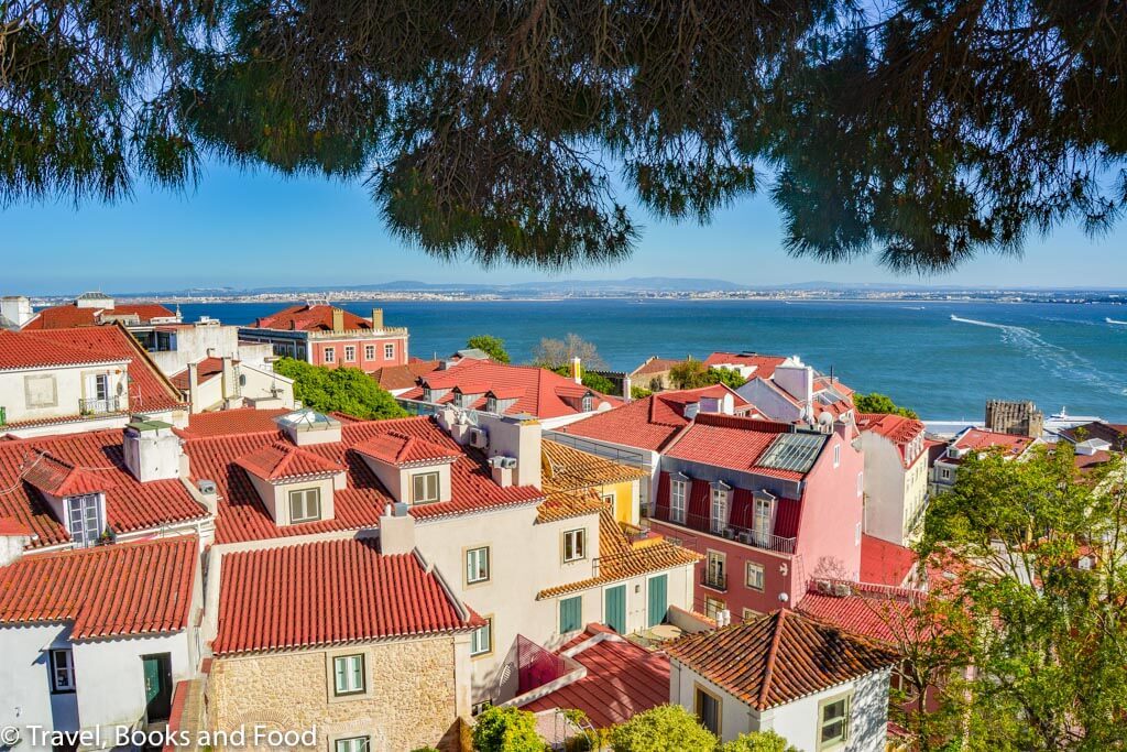 A view of Lisbon from top of San Jorge Castle with lots of brown tiled houses 