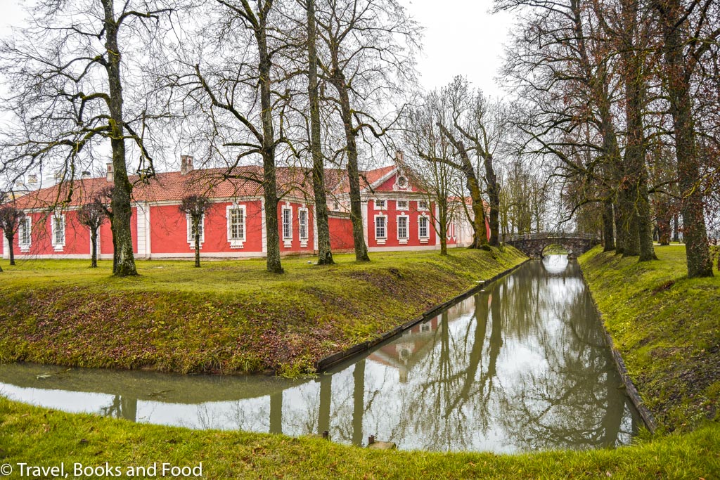 A gorgeous house in Riga, Latvia surrounded by trees with a stream in front