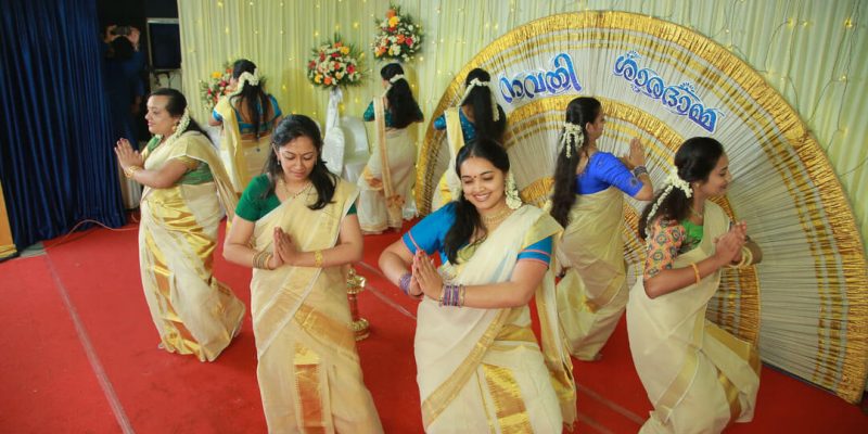 Women dancing in traditional Kerala attire